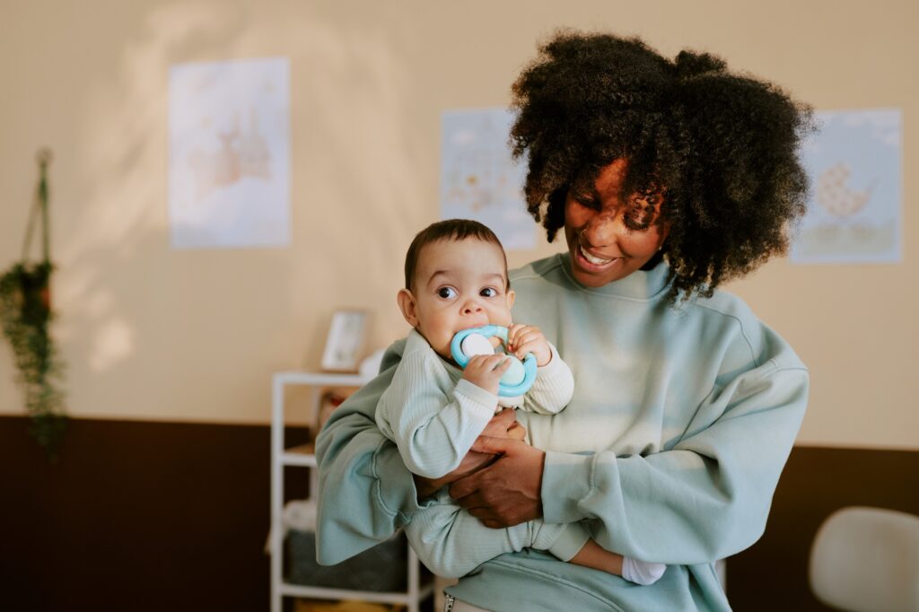 Mother Holding her Kid in Nursery